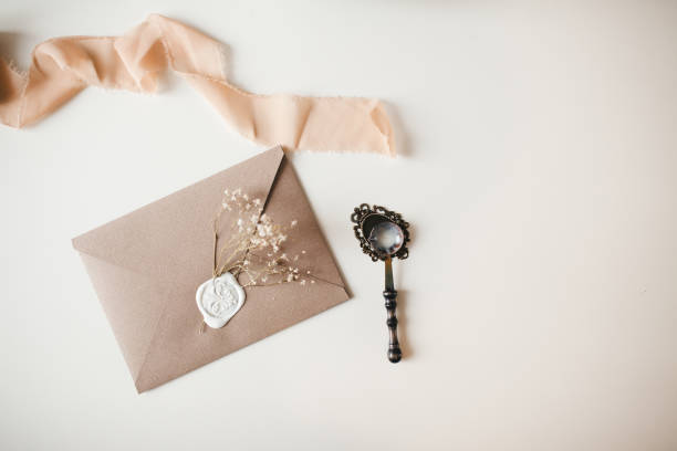 istock Tan envelope with white sealing wax flat lay on white background 1200997389