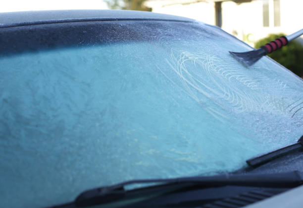 istock Scraping Ice off a Frozen Windshield in Winter 1200997399