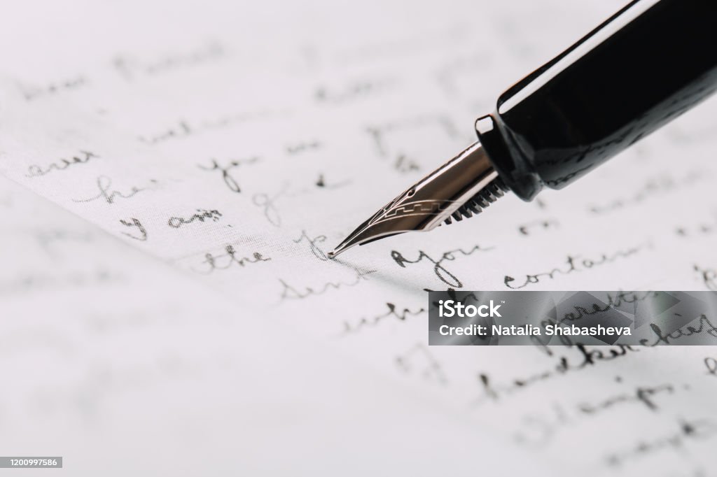 fountain pen on paper with ink text closeup Handwriting Stock Photo