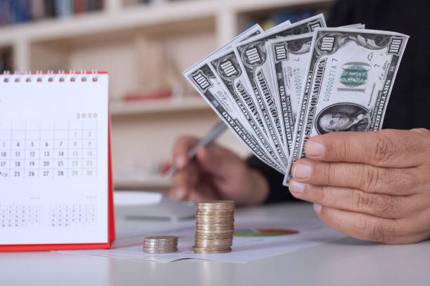 istock money and hands with calculator 1200997772