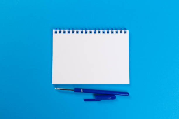 istock Sketchbook on colorful background. Copy space. top view of blank open notebook, concept of education or new workplace 1200997796
