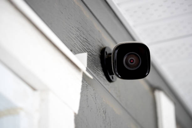 Black cctv outside building, home security system stock photo