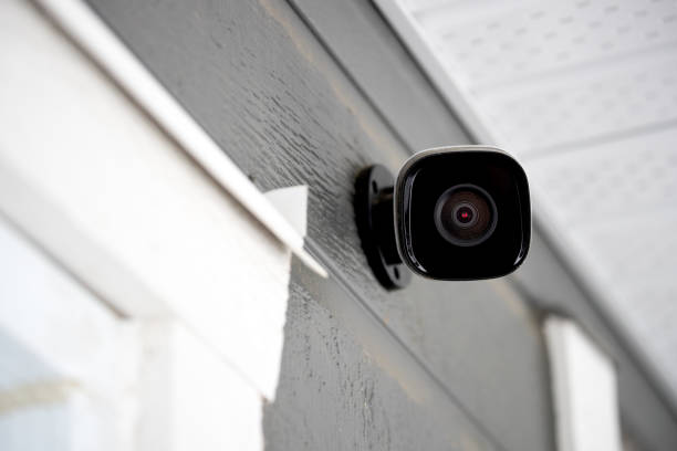 Black cctv outside building, home security system Black cctv outside the building, home security system surveillance camera stock pictures, royalty-free photos & images