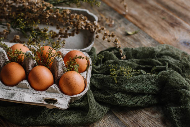 istock Eggs without staining on a wooden background in gauze in a rustic style 1200998135