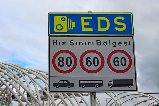 Street sign in Instanbul. Text on sign: Speed limit zone. Electronic Controlling System (EDS) Istanbul, Turkey. Concept of controlling traffic in big city.