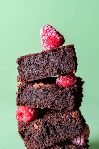 istock Stack of brownies with frozen raspberries. Chocolate cake pile 1200999217
