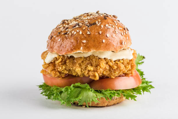 istock Classic Burger with chicken in a bun with sesame tomatoes, lettuce and mustard sauce. 1201001091