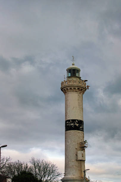 istock View of old, stone brick lighthouse under a dark, stormy sky. View from below. Winter landscape in Istanbul, Turkey 1201002392