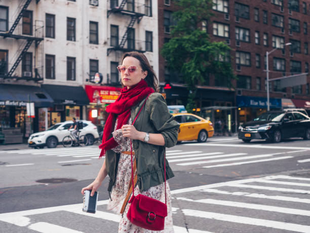 istock Attractive woman with a retro camera in New York 1201002409