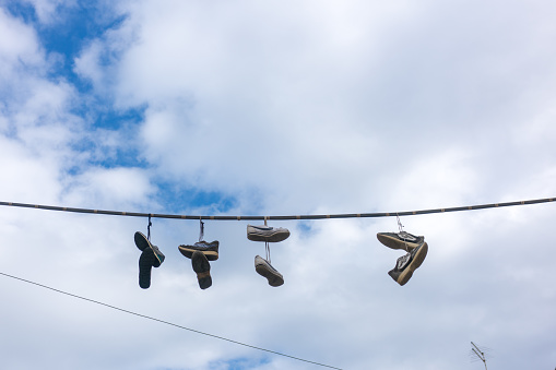 Shoes on wire in the sky