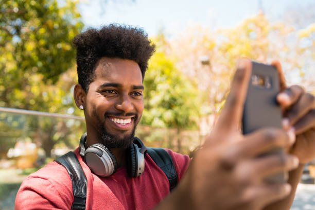 istock Afro man taking selfies with phone. 1201005583