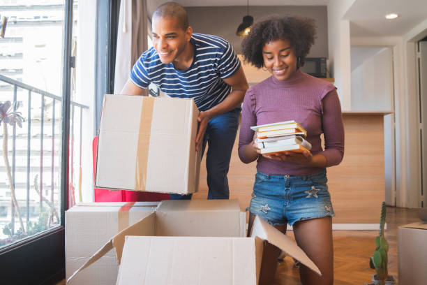 istock Latin couple unpacking at their new house. 1201005597