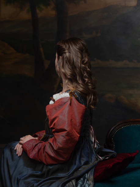 Back view Portrait of a young woman in the style of a Renaissance painting. Back view Portrait of a young woman in the style of a Renaissance painting. Beautiful mysterious girl in medieval dress back of head photos stock pictures, royalty-free photos & images