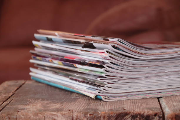 istock Old magazines on wooden table 1201010316