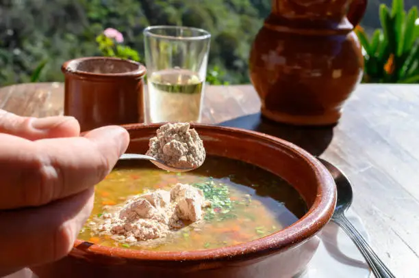 Homemade vegetables soup served on outdoor terrace with Canarian gofio flour based on local recipe of Masca village, Tenerife, Spain