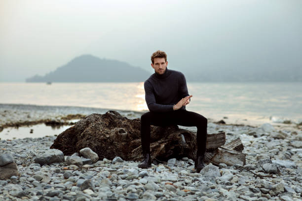 istock Handsome man relaxing on the beach near the lake 1201013013