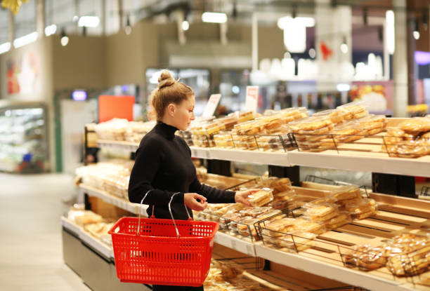 istock Woman choosing bread  from a supermarket 1201013306