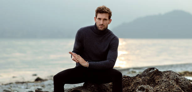 istock Handsome man relaxing on the beach near the lake 1201013429