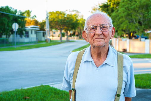 Elderly eighty year old man outdoors in a home setting.