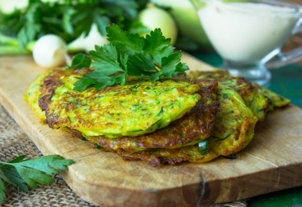 istock Pan fried zucchini fritters, traditional flat zucchini pancakes 1201014965