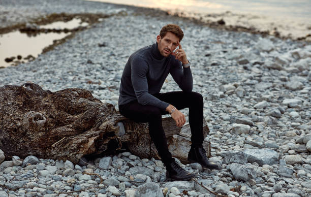 istock Handsome man relaxing on the beach near the lake 1201015033