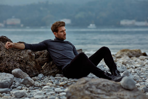 istock Handsome man relaxing on the beach near the lake 1201016019