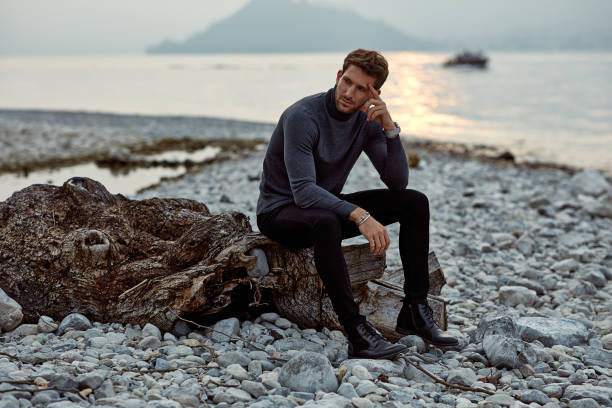 istock Handsome man relaxing on the beach near the lake 1201016022