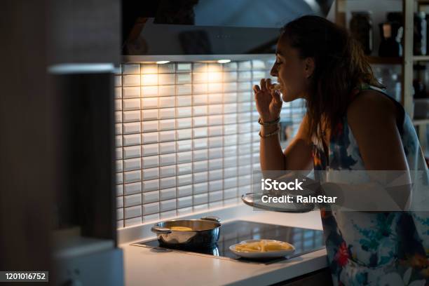 Young Woman Having A Midnight Snack Stock Photo - Download Image Now - Night, Eating, Snack