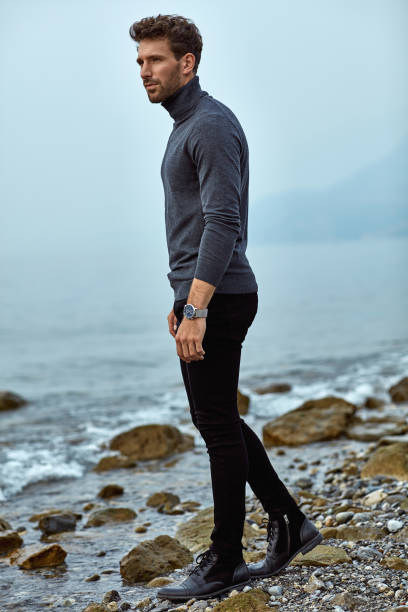 istock Handsome man relaxing on the beach near the lake 1201017532