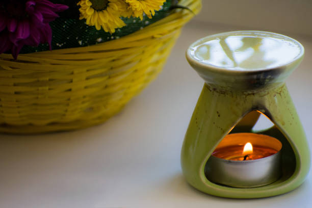 istock Oil burner with chrysanthemums by the side. Aromatherapy burner. Oil, aromatherapy burner, flowers and candles for spa and relaxation. 1201018935