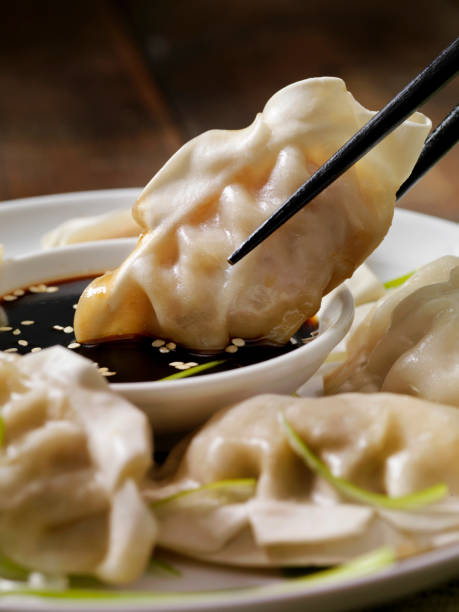 Steamed Asian Pork Dumplings with Soy Sauce and Green Onions Steamed Asian Pork Dumplings with Soy Sauce and Green Onions chinese dumpling stock pictures, royalty-free photos & images