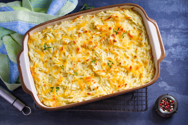 Shepherd's Pie or Cottage Pie. Casserole in baking dish Shepherd's Pie or Cottage Pie. Casserole in baking dish. Overhead horizontal image mashed potatoes stock pictures, royalty-free photos & images
