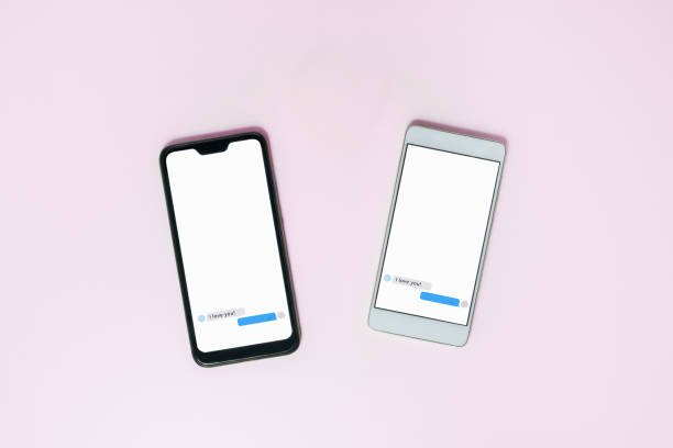 istock Two phones with open messenger on screen. 1201022386