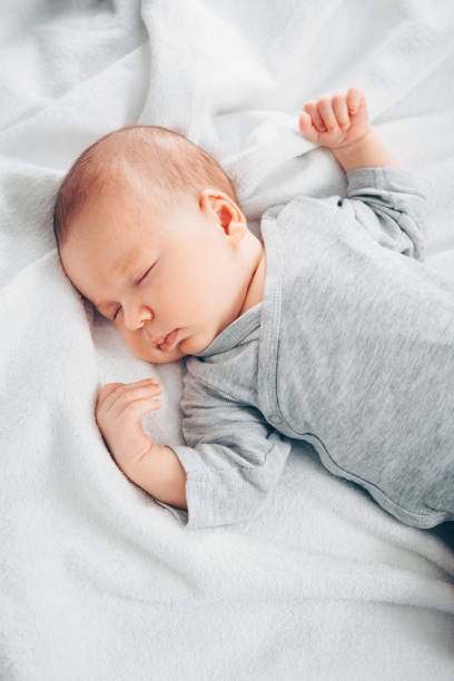 istock Sleeping newborn baby boy in bed. 1201024305