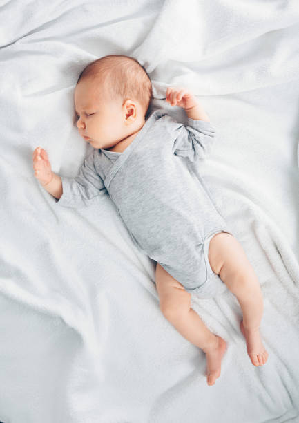 istock Sleeping newborn baby boy in bed. 1201024309