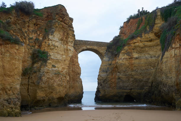 istock Beach with arch bridge students beach beach beach in Lagos, Portugal 1201024731