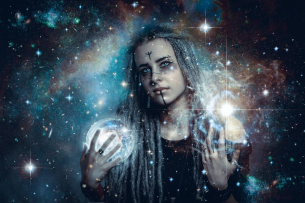 istock Young beautiful fortune teller with a magic crystal ball. 1201025866