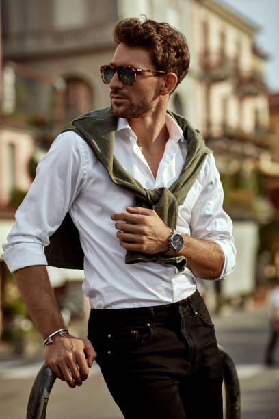 Stylish man wearing sunglasses and white shirt. City life stock photo