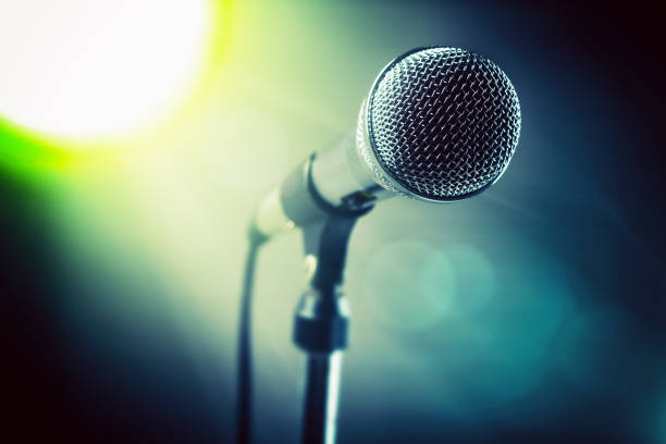 backlit microphone spot lit on stage - brightly lit audio imagens e fotografias de stock