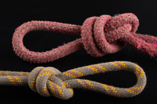 Two loops made of thick rope. Loop-shaped knot. Dark background.