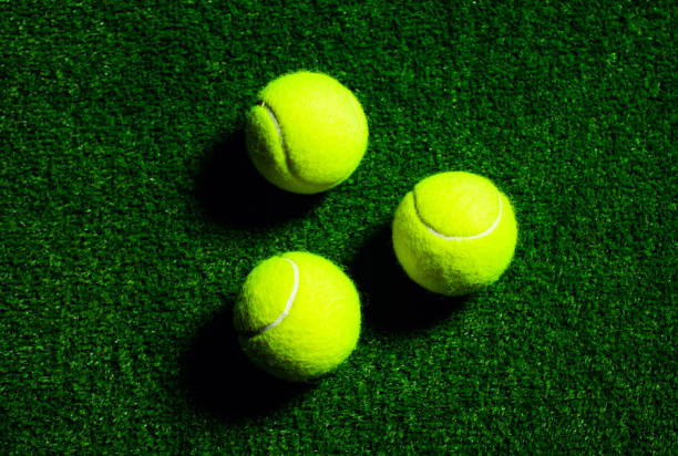 istock Tennis Ball isolated on black with dramatic lighting 1201027284