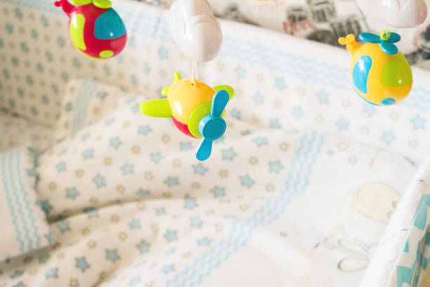 istock children's mobile toy for a cradle in the nursery on a light background, a toy for development of kids 1201027755
