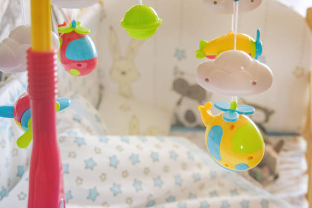 children's mobile toy for a cradle in the nursery on a light background, a toy for development of kids, a bedside toy