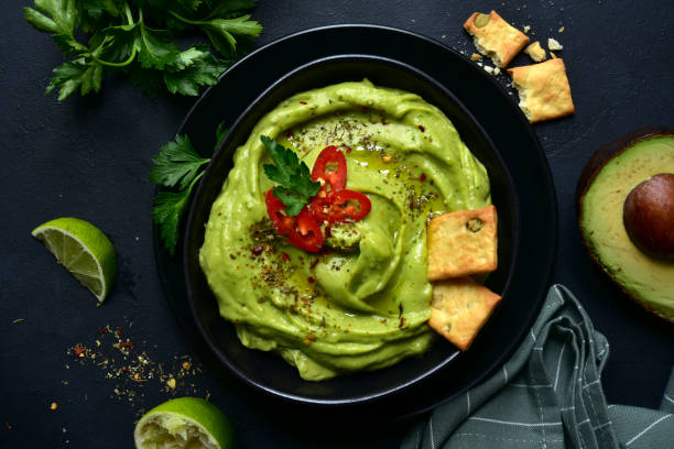 istock Guacamole - traditional mexican spicy avocado dip 1201027868