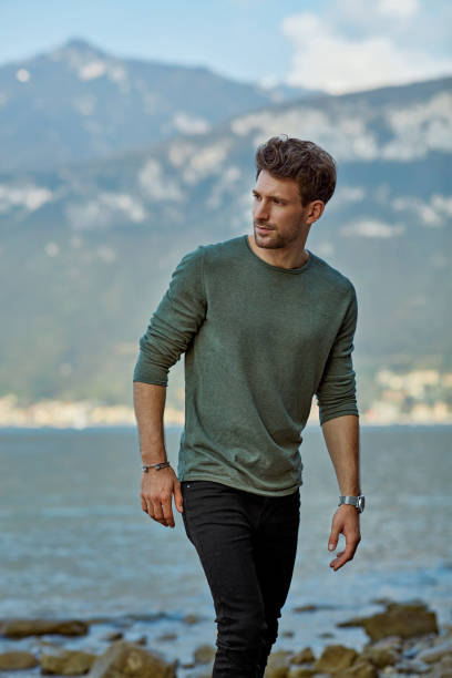 istock Handsome man in casual clothing relaxing on the beach 1201031946