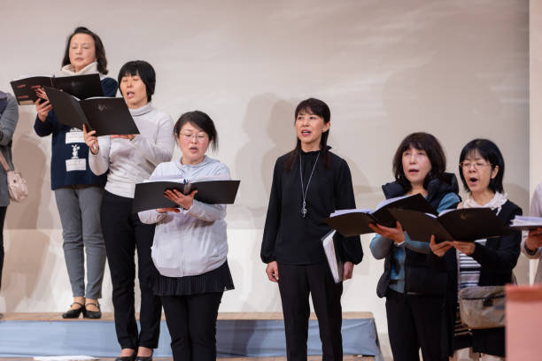 istock Female singers singing at women's chorus concert 1201035144