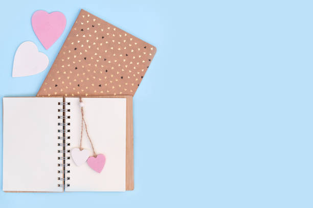 istock Notebooks with pink and white wooden hearts on them 1201038662