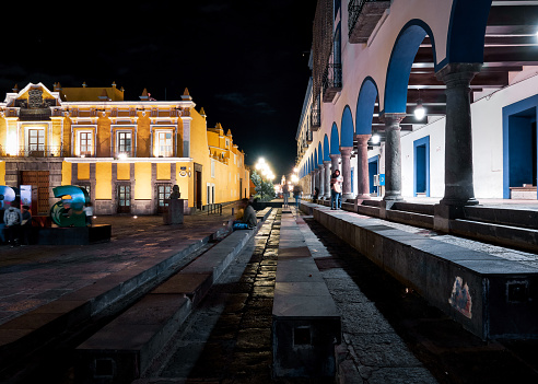 Puebla de Zaragoza, Mexico, October 15, 2018 - Square of Teatro Principal with porch of Secretaria de Salud Del Estado De Puebla at night