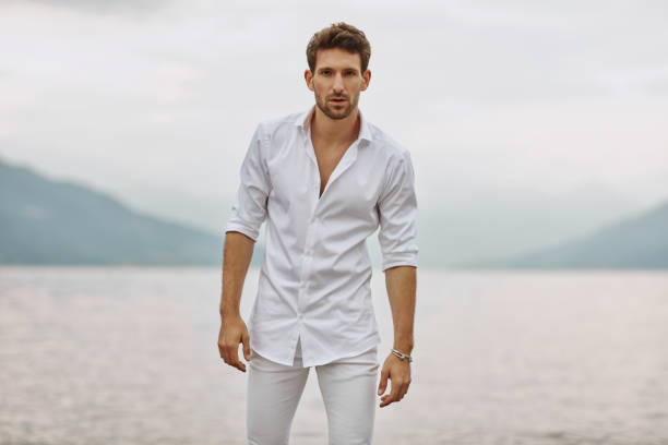 istock Handsome man in casual clothing relaxing on the beach 1201043301