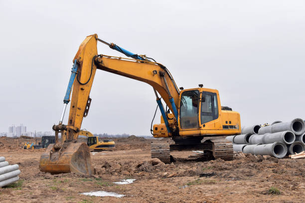 istock Excavator with a large iron bucket on a construction site during road works. 1201044110